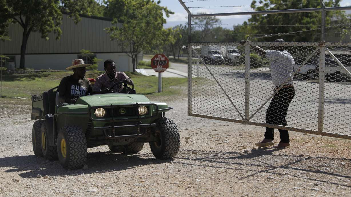 Workers ride out of the gate of the Christian Aid Ministries headquarters in Titanyen, north of Port-au-Prince, Haiti, Dec. 6. All members of a missionary group who were kidnapped have been freed, Haiti police said Thursday.