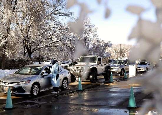 People wait in line at a COVID-19 test site at the Cannon Health Building in Salt Lake City on Wednesday, Dec. 15, 2021.