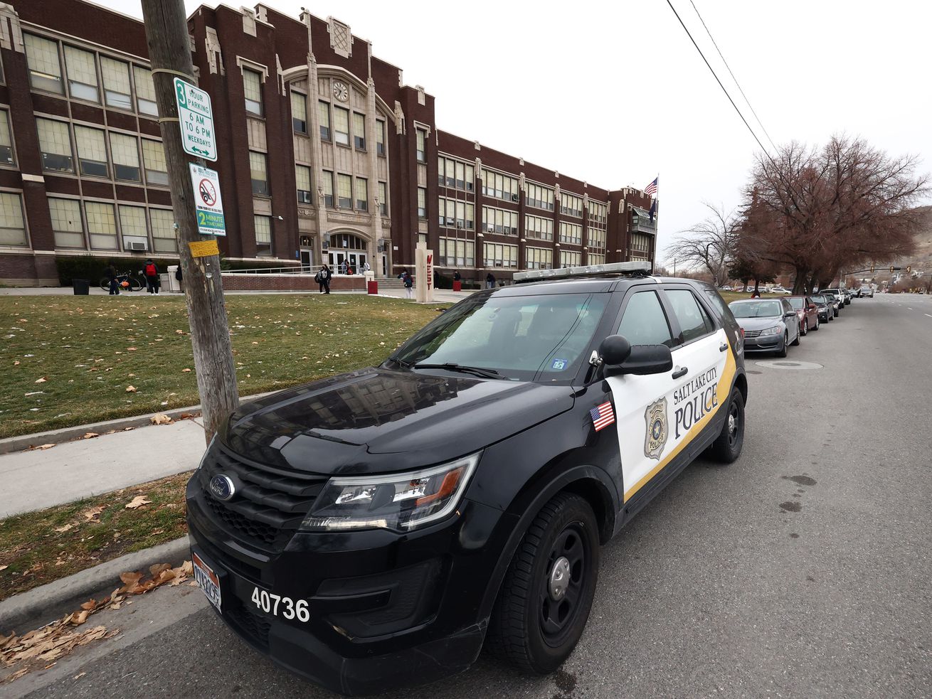 A police vehicle is parked in front of West High School in Salt Lake City on Monday.