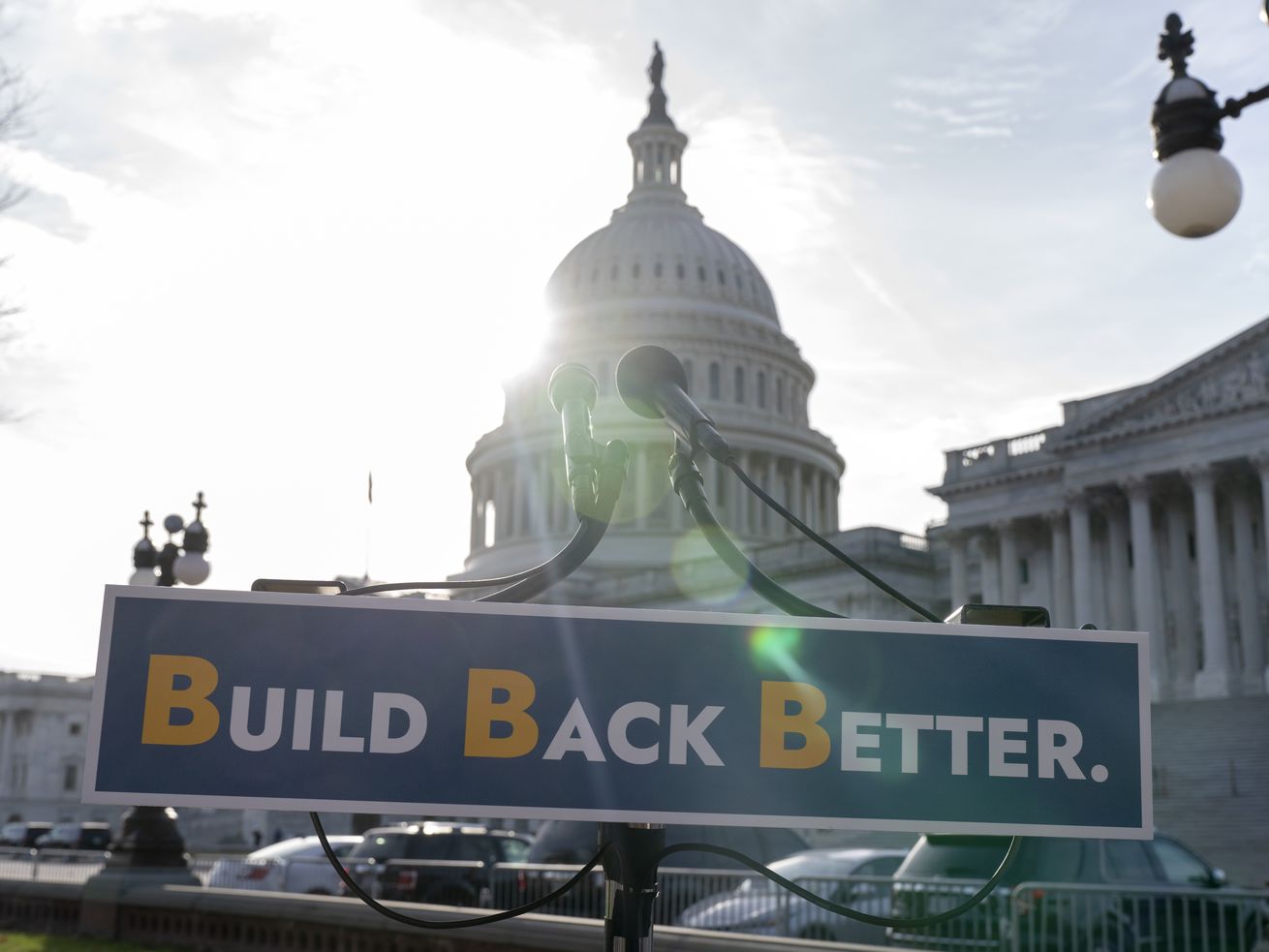 With the U.S. Capitol dome in the background, a sign
that reads "Build Bake Better” is displayed before a news
conference, Wednesday, on Capitol Hill in
Washington.