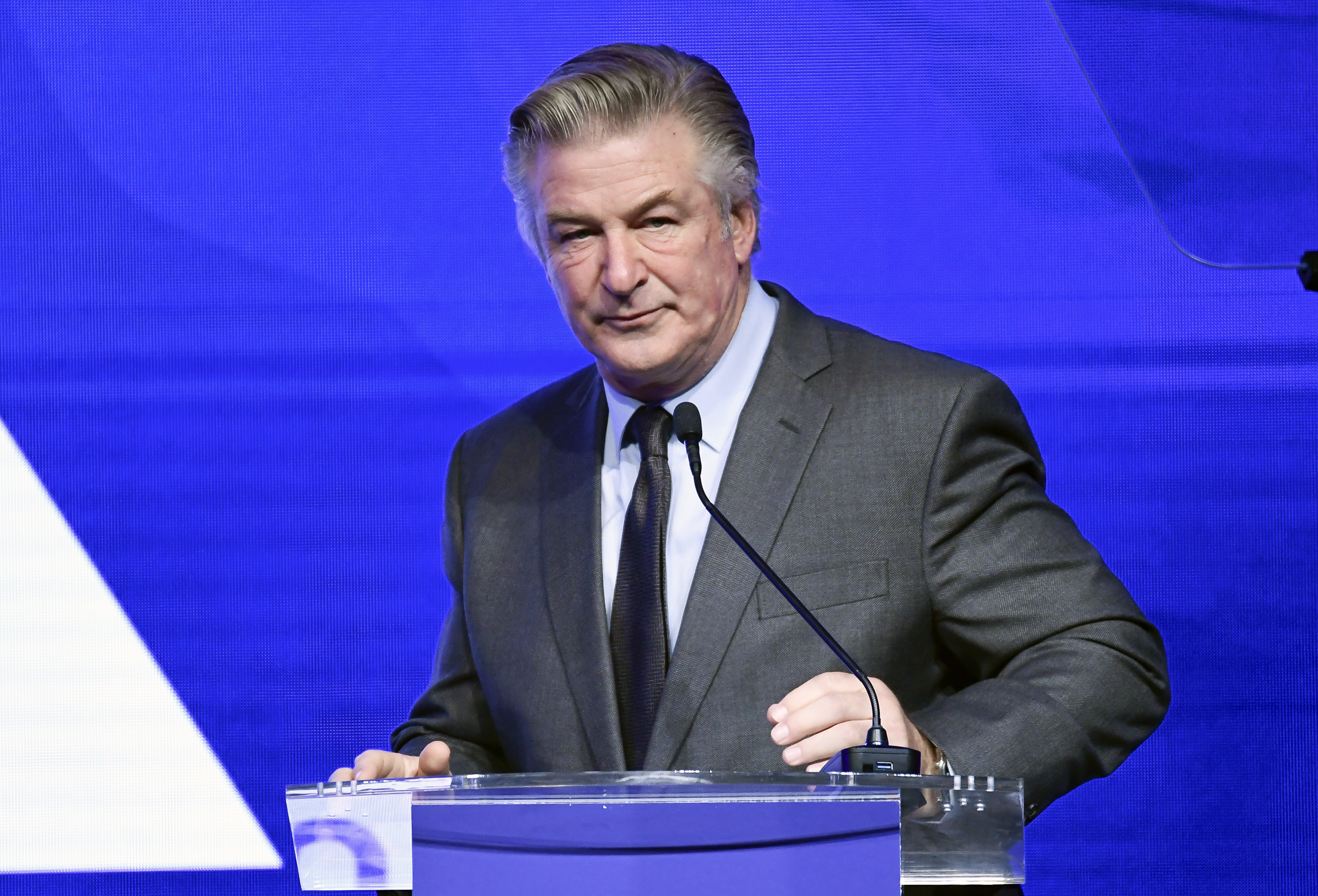 Alec Baldwin performs emcee duties at the Robert F. Kennedy Human Rights Ripple of Hope Award Gala on Dec. 9 in New York. Authorities on Thursday issued a search warrant for Baldwin's cell phone.