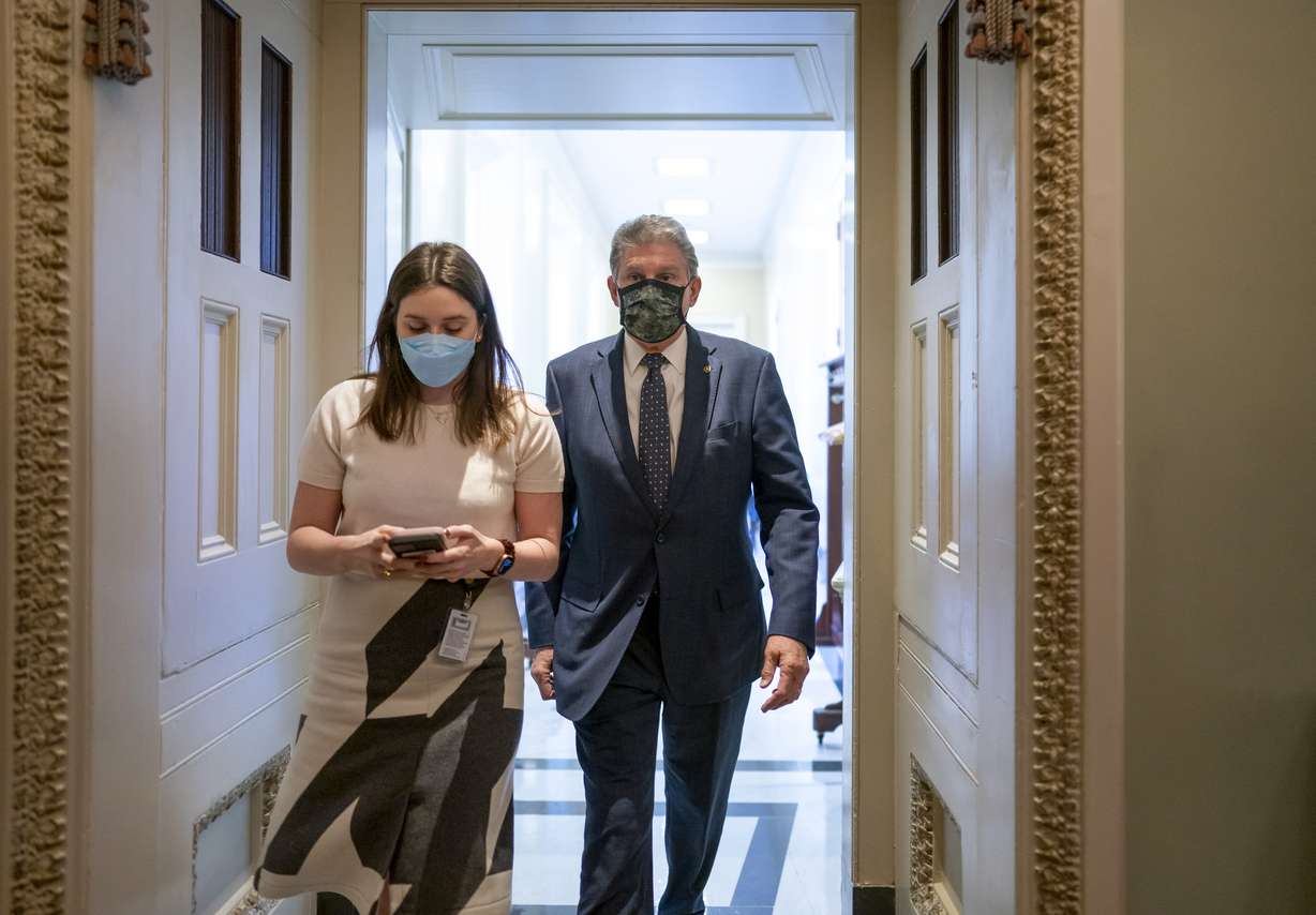 Sen. Joe Manchin, D-W.Va., leaves a lengthy Democratic Caucus meeting as the Senate continues to grapple with end-of-year tasks at the Capitol in Washington, Thursday.