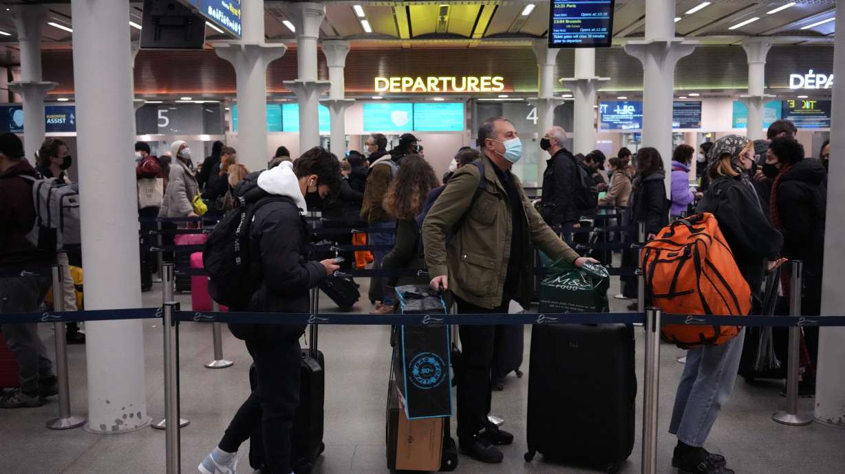 People queue up to travel on trains at London St. Pancras International rail station, in London, the Eurostar hub to travel to European countries including France, on Friday.