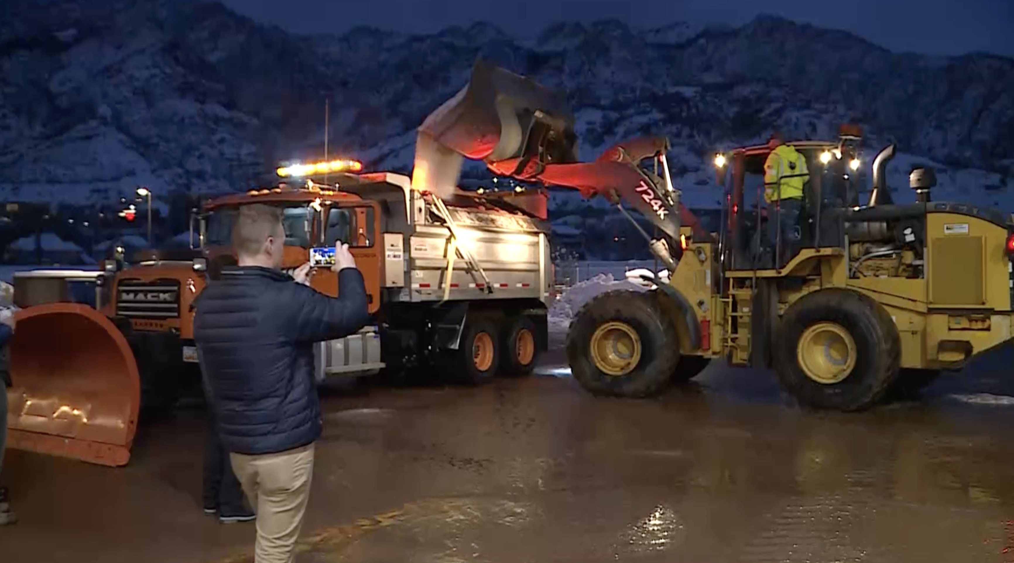 Gov. Spencer Cox loads salt into a snowplow at the Cottonwood Canyons Maintenance Station Friday morning. 