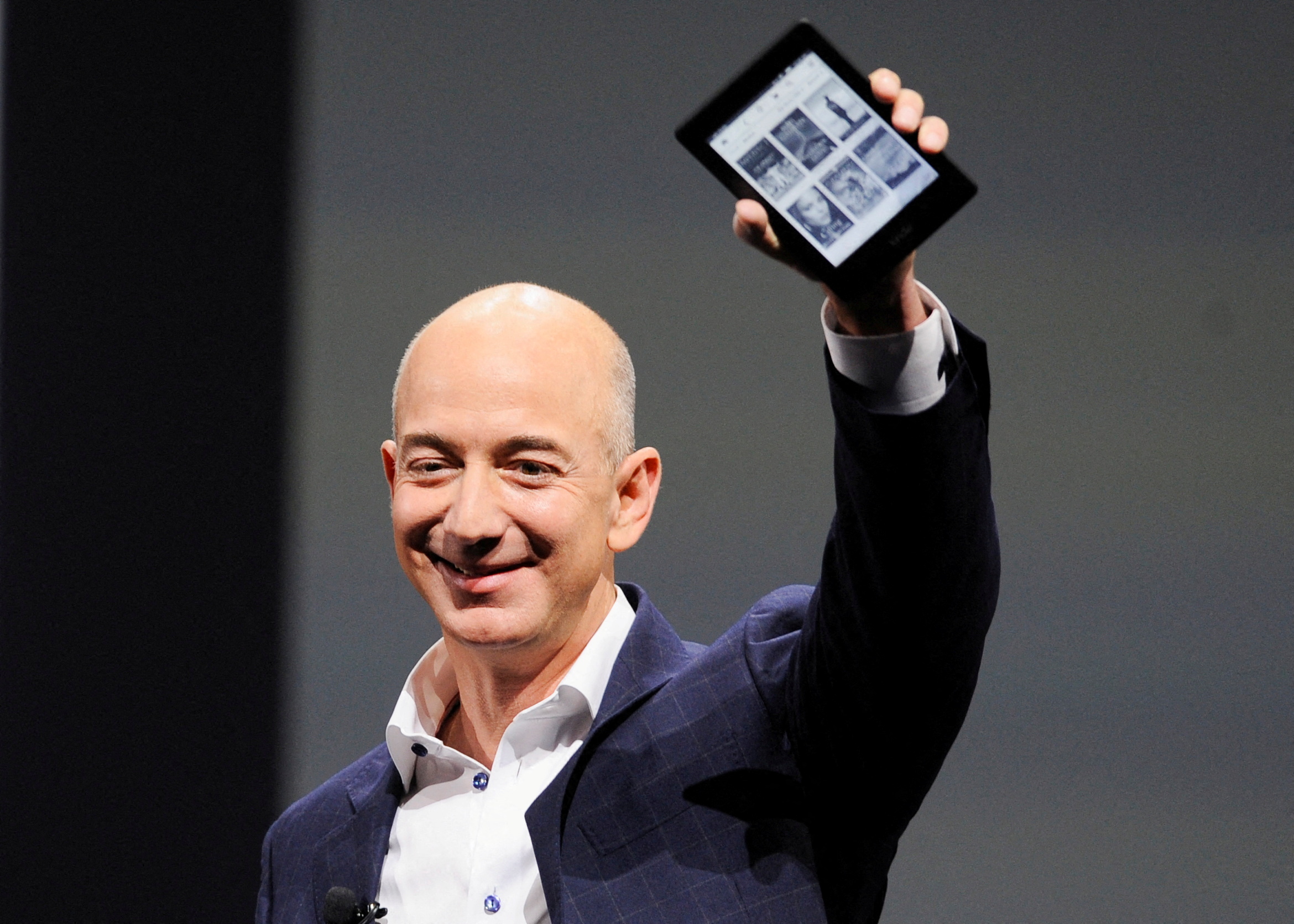 Amazon CEO Jeff Bezos holds up a Kindle Paperwhite during Amazon's Kindle Fire event in Santa Monica, California Sept. 6, 2012. 