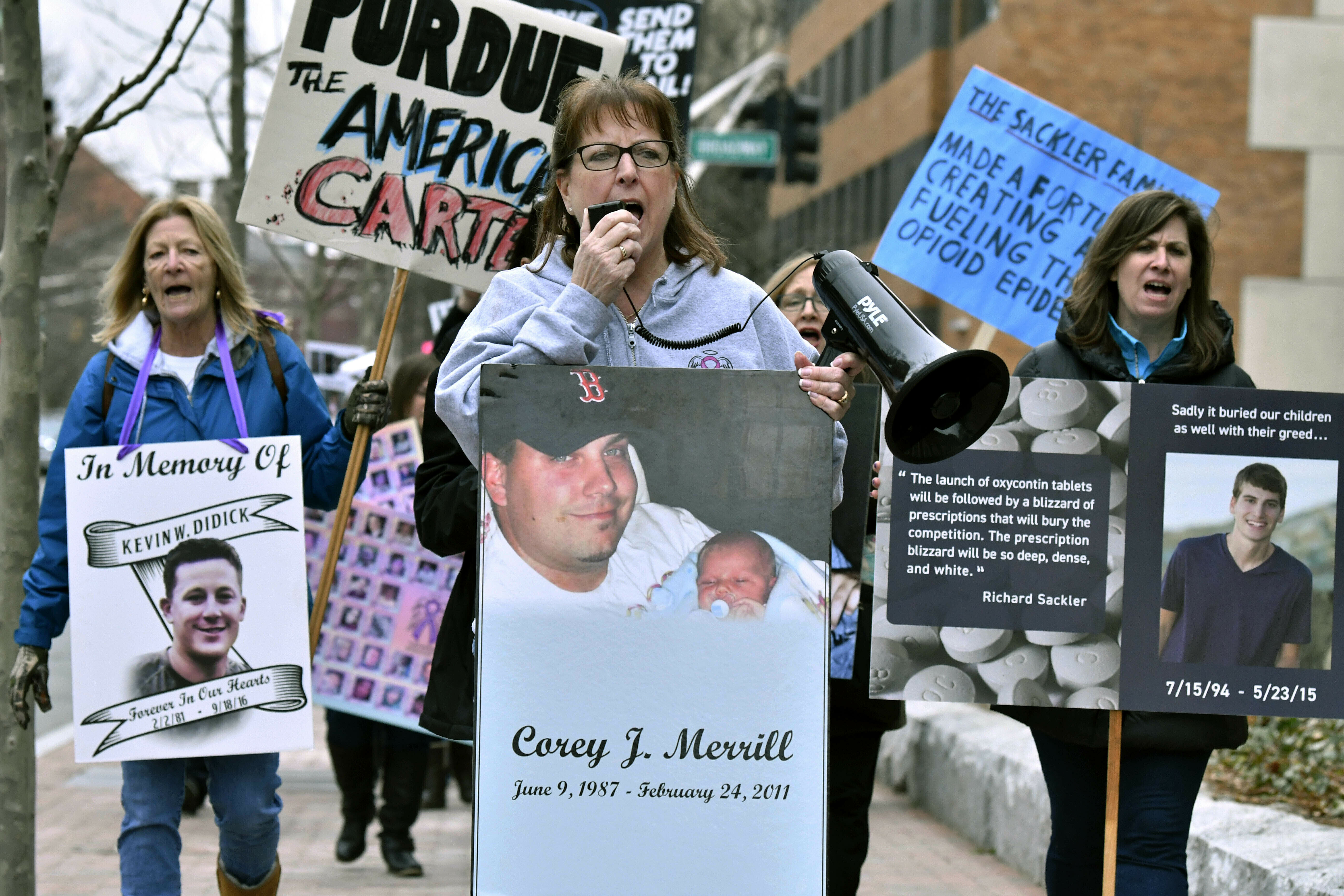 Cheryl Juaire, of Marlborough, Mass., center, leads a protest near the Arthur M. Sackler Museum at Harvard University, in Cambridge, Mass., on April 12, 2019.  