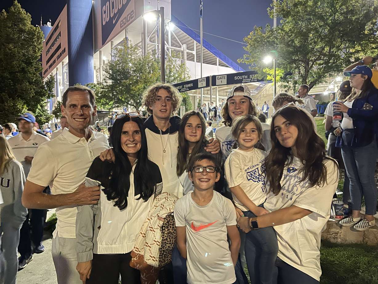 Nathan Peterson and his wife Emily, left, with their six children — Eliza, 19; Isaac, 17; Samuel, 15; and Sarah Sophia, 13; Jeremiah, 10; and Grace, 5 — at a recent BYU football game.