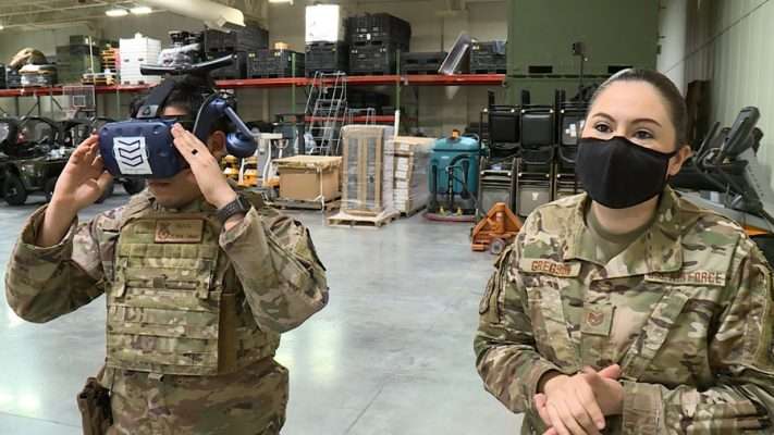 Senior Airman Garza and Tech Sgt. Elizabeth Gregson train with virtual reality headsets.