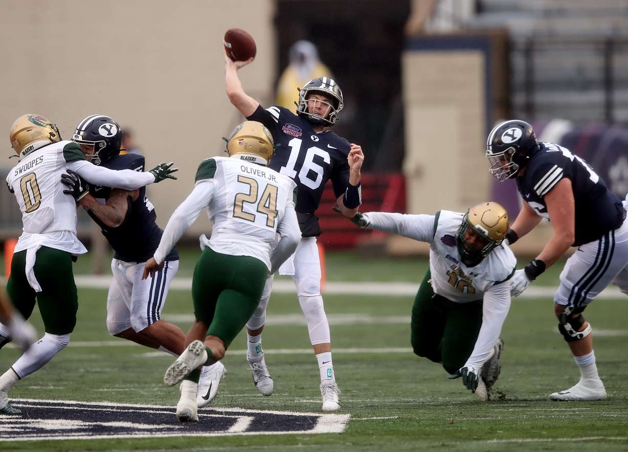Brigham Young Cougars quarterback Baylor Romney (16) passes the ball just ahead of the Blazers rush as BYU and UAB play in the Radiance Technologies Independence Bowl in Shreveport, Louisiana on Saturday, Dec. 18, 2021.