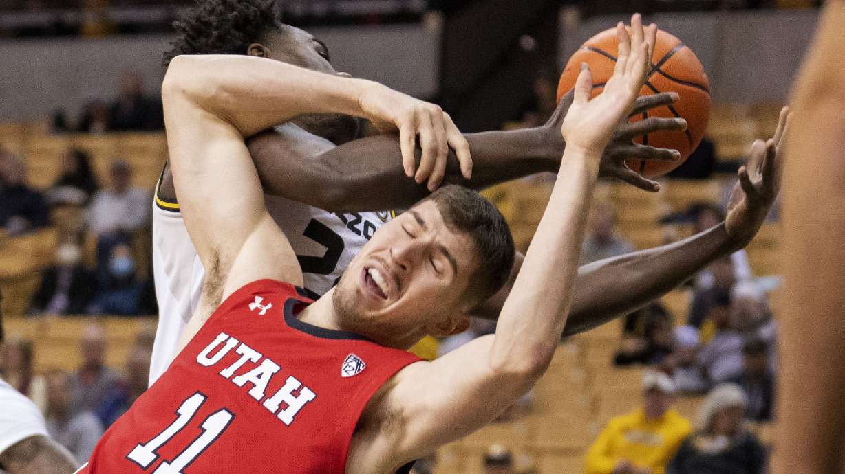 Utah's Riley Battin (11) battles Missouri's Kobe Brown for a rebound during the first half of an NCAA college basketball game Saturday, Dec. 18, 2021, in Columbia, Mo.