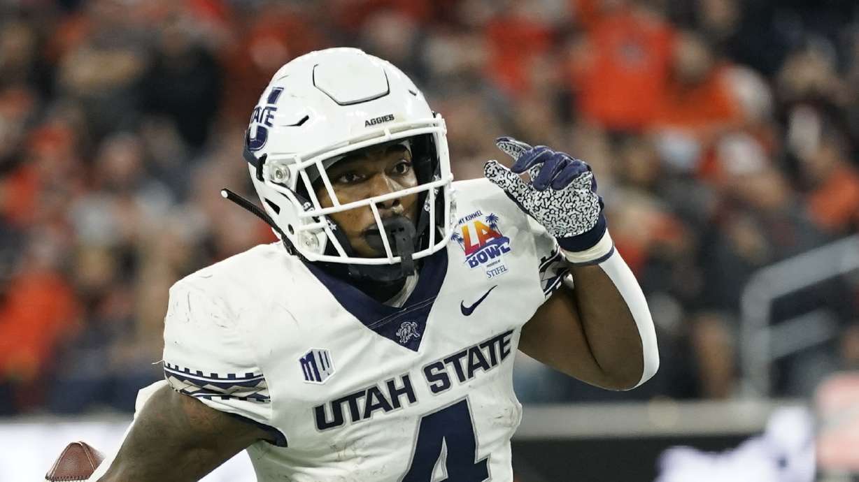 Utah State running back Calvin Tyler Jr. (4) runs to the end zone for a touchdown during the first half of the LA Bowl NCAA college football game against Oregon State in Inglewood, Calif., Saturday, Dec. 18, 2021.