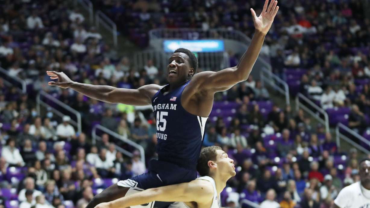 Brigham Young Cougars forward Fousseyni Traore (45) tries to grab a rebound over Weber State Wildcats forward Dyson Koehler (44) in Ogden on Saturday, Dec. 18, 2021. BYU won 89-71.