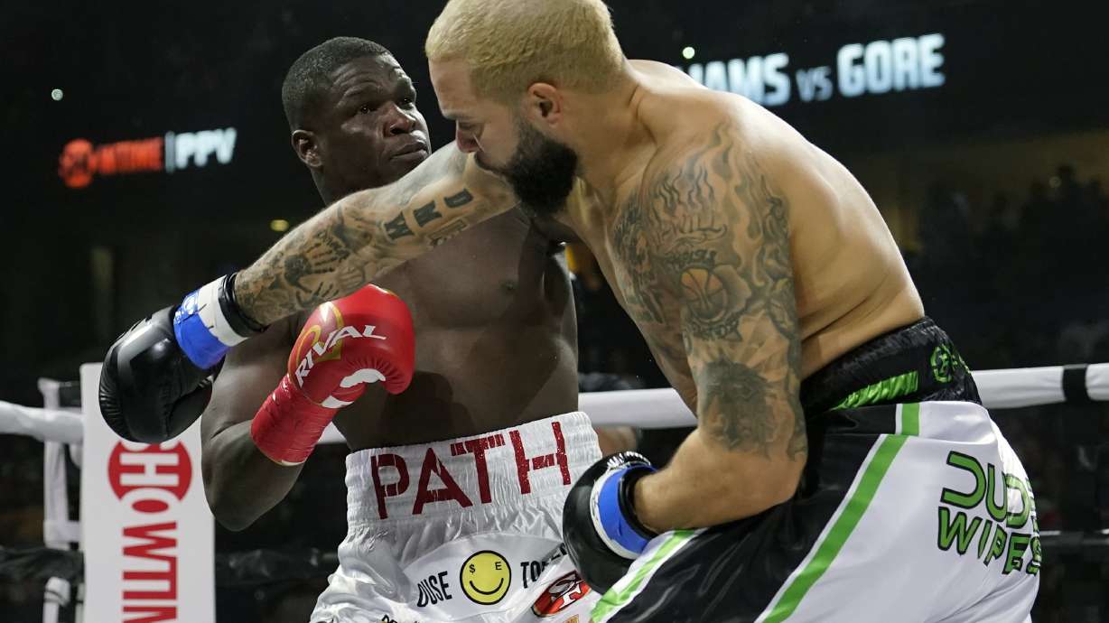 Frank Gore, left, and Deron Williams box during the first round of a heavyweight special attraction fight Saturday, Dec. 18, 2021, in Tampa, Fla.