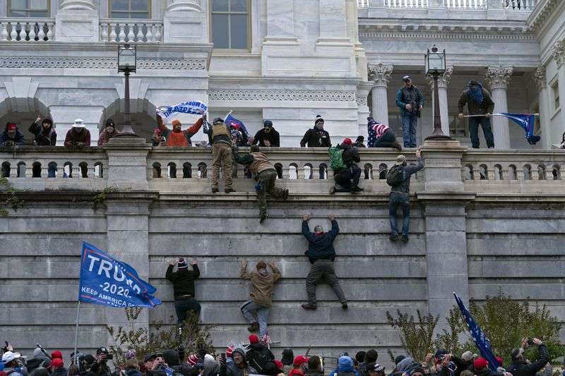 Supporters of President Donald Trump climb the west
wall of the U.S. Capitol in Washington as they try to storm the
building on Jan. 6, while inside Congress prepared to affirm
President-elect Joe Biden’s election victory.