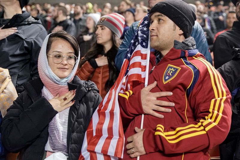 Shazia Kakaie, left, and her husband, Azim Kakaie,
stand during the national anthem before a soccer match between Real
Salt Lake and Portland at Rio Tinto Stadium in Sandy on 
Nov. 3. Azim Kakaie was the first Afghan refugee to arrive in
Utah in the wake of the evacuation of Kabul.