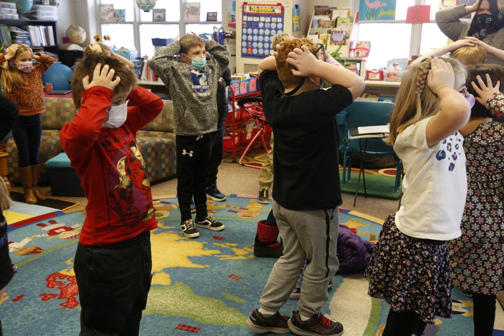Second graders hold their heads as they talk about "thoughts" and how they compare with "feelings" and resulting "actions," at Paw Paw Elementary School on Dec. 2, in Paw Paw, Michigan. Their teacher is one of many in the school trained to use a curriculum aimed at reducing depression and improving coping skills.

