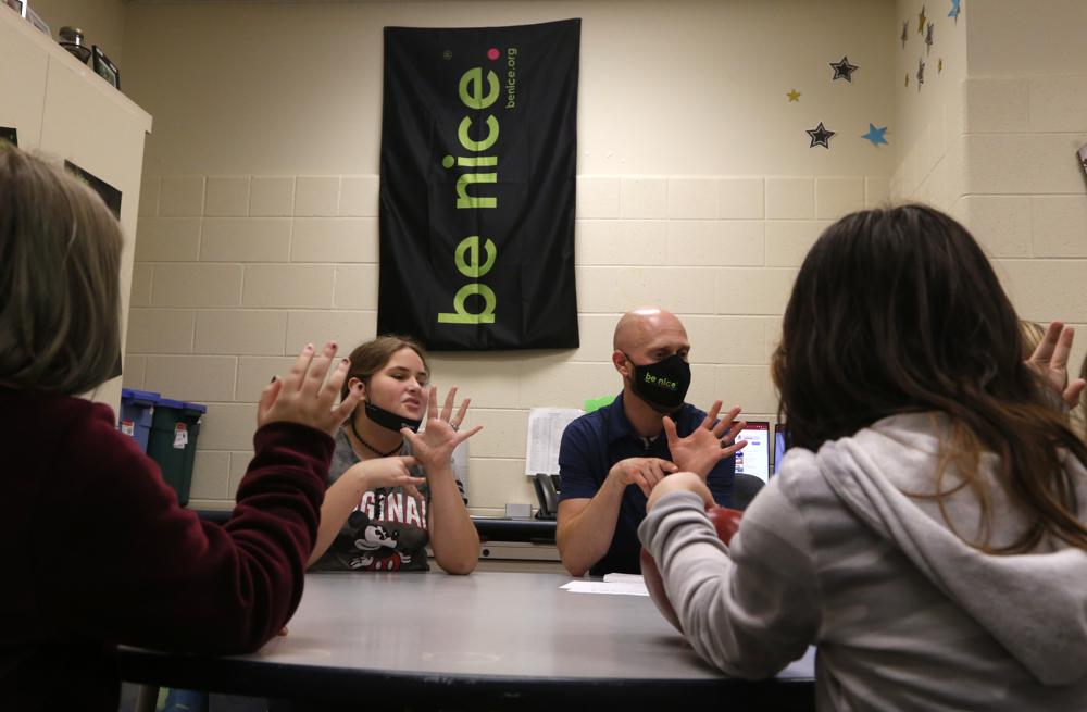 Behavior specialist Eric Clark, center right, leads a group of fifth graders in a mindfulness exercise on Dec. 2, in Paw Paw, Michigan.