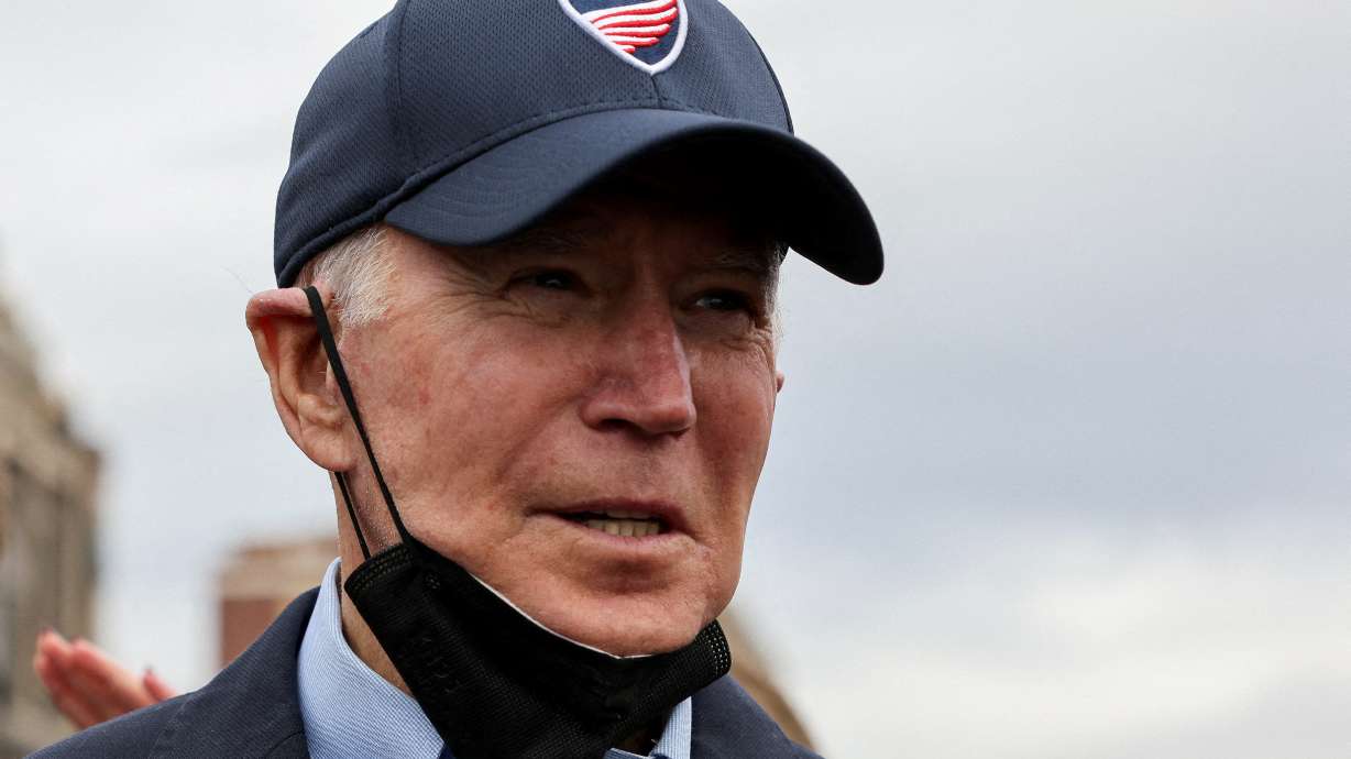 President Joe Biden looks on as he tours a neighborhood, in Mayfield, Ky., Wednesday. Over the weekend, dozens of states, businesses and religious groups asked the U.S. Supreme Court to block the Biden vaccine mandate.