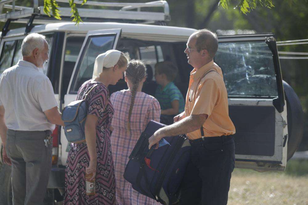 Unidentified people board a vehicle departing to the airport from the Christian Aid Ministries headquarters at Titanyen, north of Port-au-Prince, Haiti, Thursday. Twelve remaining members of a U.S.-based missionary group who were kidnapped two months ago have been freed, according to the group and to Haitian police.