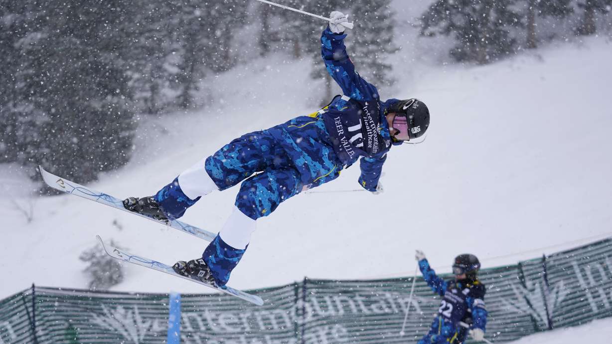 Kai Owens, left, and Olivia Giaccio compete during qualifying in the World Cup women's dual moguls skiing competition, Friday, Feb. 5, 2021, in Deer Valley, Utah. As an infant, she was abandoned at a town square in a province of China. Taken to an orphanage, she was adopted by a couple from Colorado at 16 months. Now 17, U.S. freestyle skier Kai Owens is on the verge of earning a spot in moguls for the Winter Games in Beijing. It's a return to China she's long thought about.