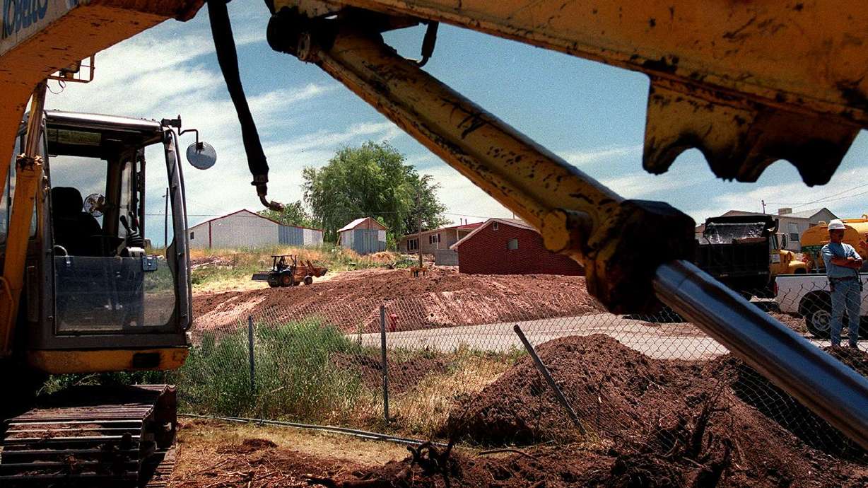 Environmental Chemical Corporation is pictured in this
June 1999 file photo cleaning up in the town of Stockton, Tooele
County, near a toxic superfund site.