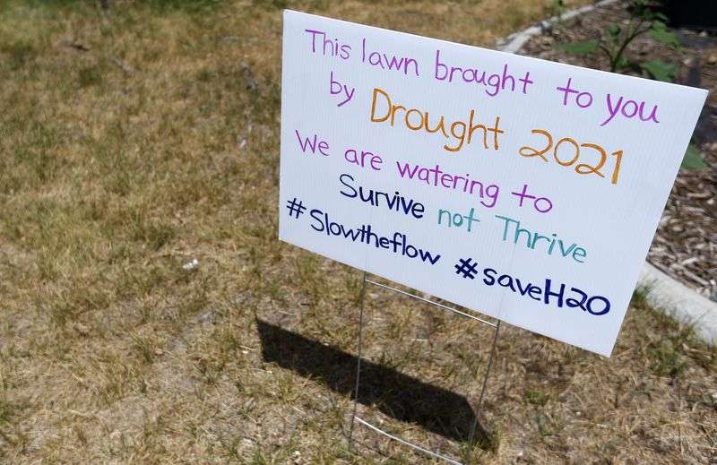A sign in Emmalee Nelson Thompson’s Magna yard explains
her decision not to water her lawn on Friday, July 2,
2021.