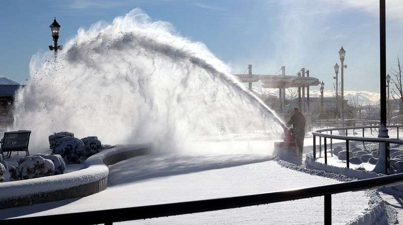 Jeff Kern removes snow from the ice skating area at the
Herriman Towne Center on Wednesday, Dec. 15, 2021.