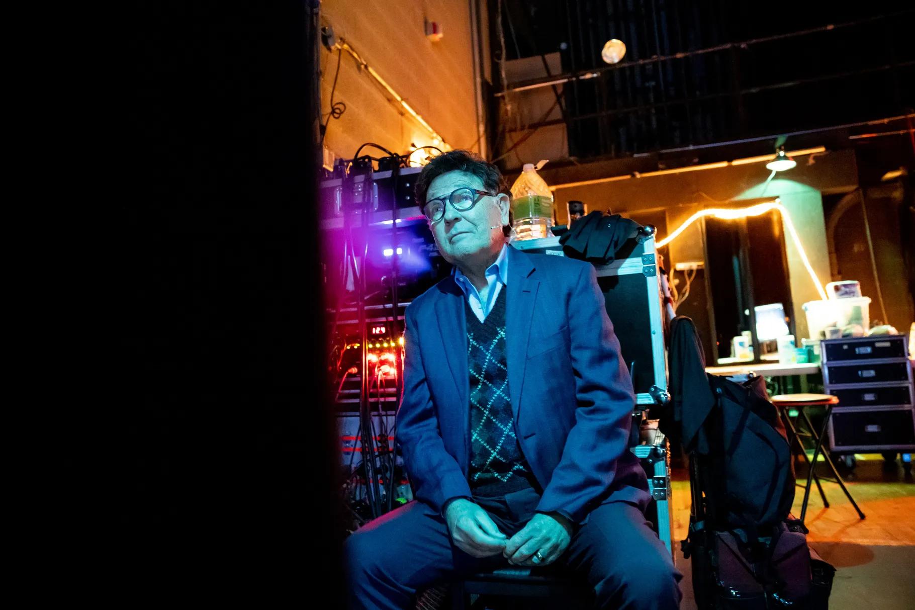 Michael McLean watches the show from backstage during a performance of “The Forgotten Carols” at Cottonwood High School in Murray on Saturday.