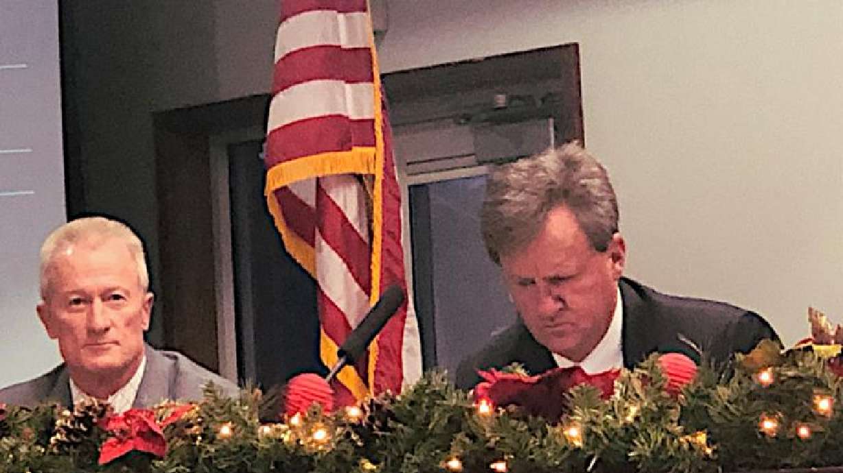 Superintendent Larry Bergeson, left, seen next to council member David Stirland, cast the tie-breaking vote that resulted in the ban of “Out of Darkness,” in St. George, Dec. 14.