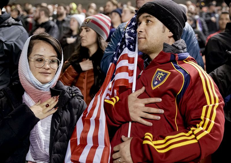 Shazia Kakaie, left, and her husband, Azim Kakaie,
stand during the national anthem before a soccer match between Real
Salt Lake and Portland at Rio Tinto Stadium in Sandy on Wednesday,
Nov. 3, 2021.