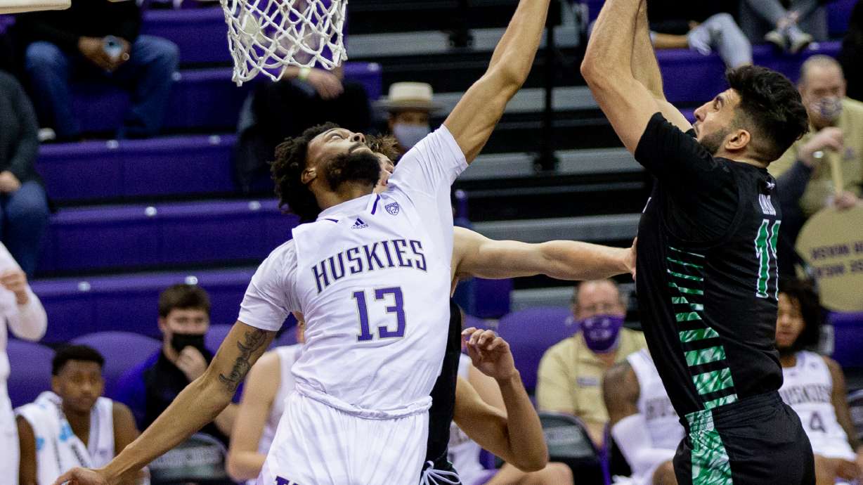 Utah Valley forward Fardaws Aimaq shoots over Washington during an NCAA college basketball game, Tuesday, Dec. 21, 2021 in Seattle.