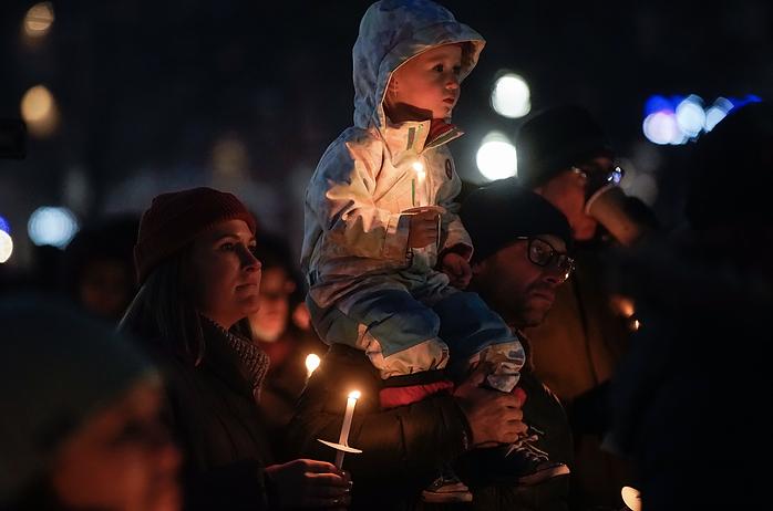 Cameron Diachun, 3, center, Nick Diachun, right, and Jaime Diachun listen to the speakers at the 2021 Homeless Persons Memorial Candlelight Vigil at Pioneer Park in Salt Lake City on Tuesday. The vigil honored the 117 men and women who died in Salt Lake City while experiencing homelessness over the past year.