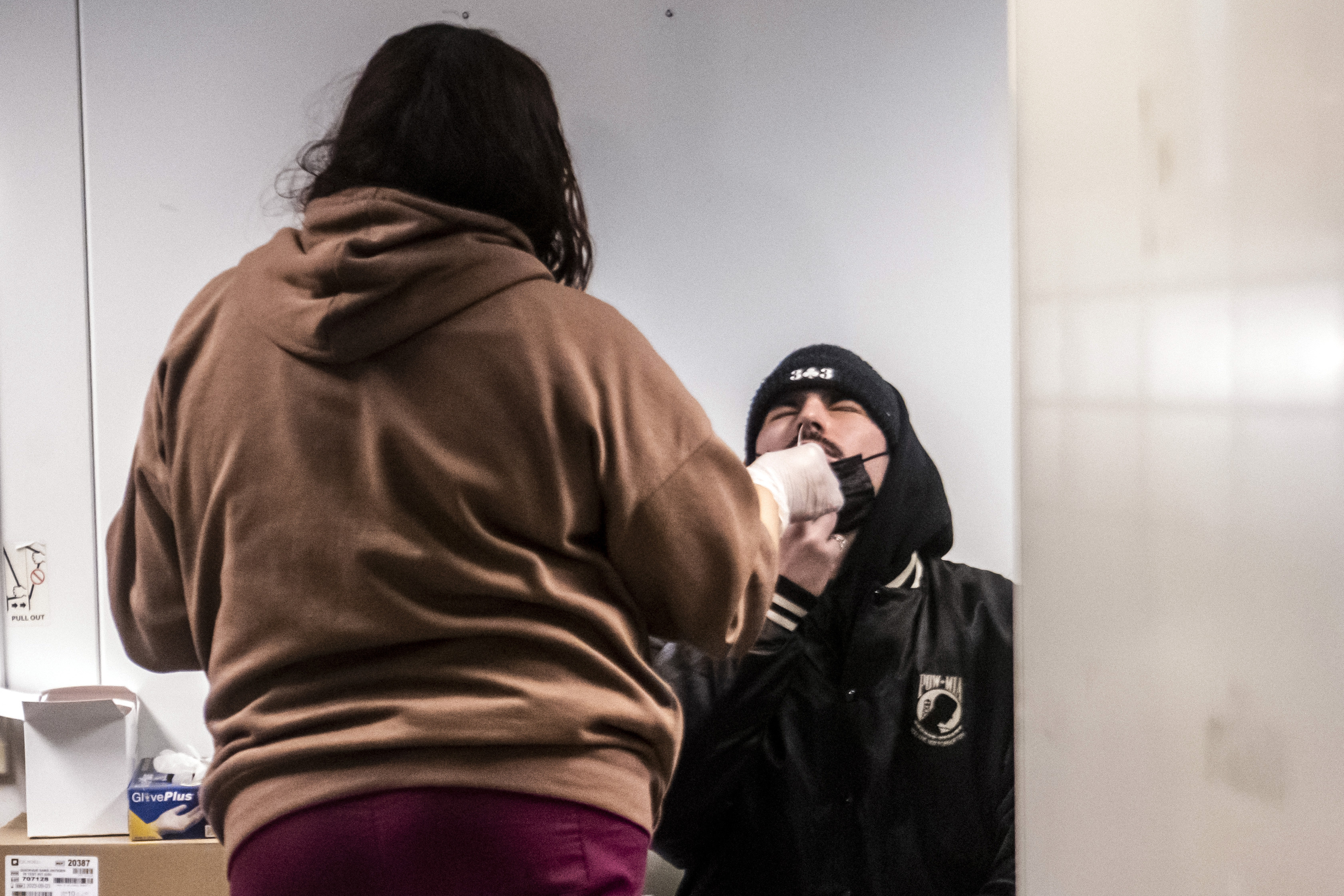 Spencer Savitz gets tested for COVID-19 on the Lower East Side of Manhattan on Dec. 21 in New York. U.S. health officials are calling on Americans to get tested for COVID-19 before they travel and gather for the holidays. But what should you do if you test positive?