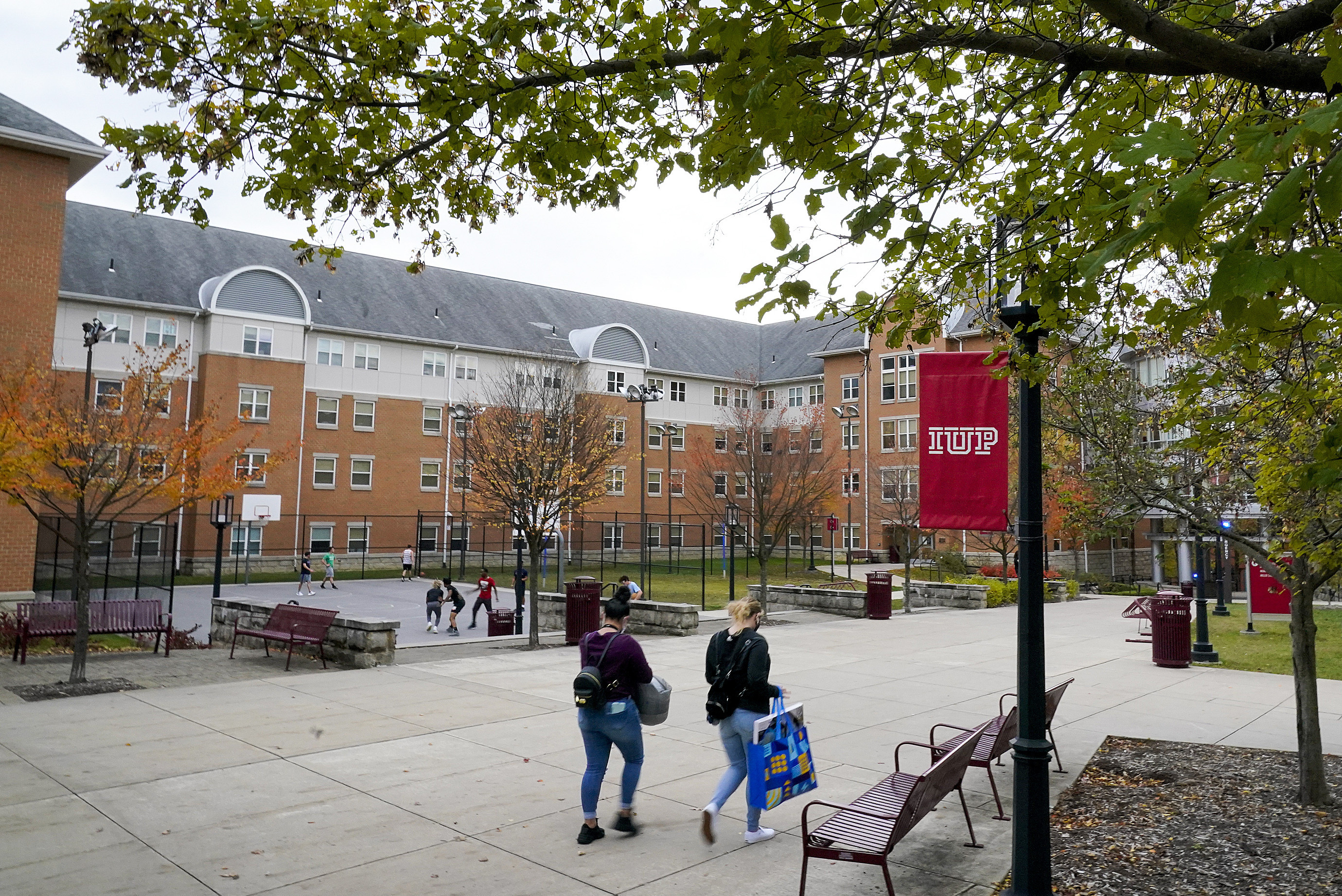 Students walk on the campus of Indiana University of Pennsylvania in Indiana, Pa., Oct. 21, 2020. The Biden administration on Wednesday extended a student loan moratorium through May 1, 2022. 