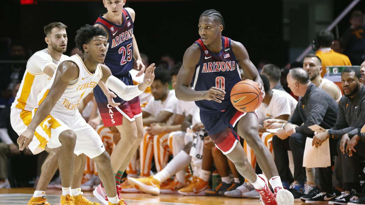 Arizona guard Bennedict Mathurin (0) dribbles as he's defended by Tennessee guard Kennedy Chandler (1) during an NCAA college basketball game Wednesday, Dec. 22, 2021, in Knoxville, Tenn.