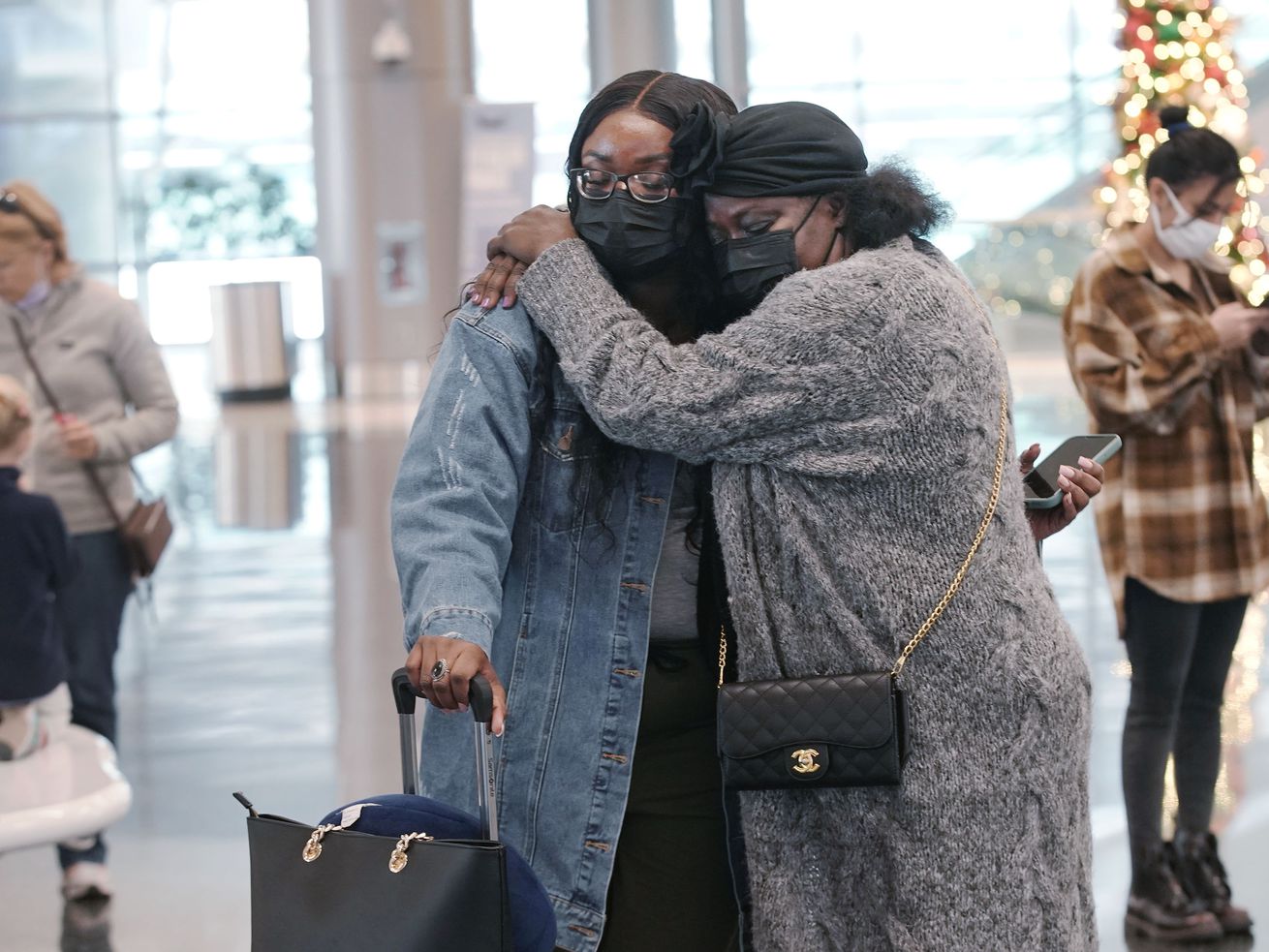 Monica Annoh, left, gets a hug from her mother Eunice
Lamptey before her departure at Salt Lake City International
Airport in Salt Lake City on Wednesday.