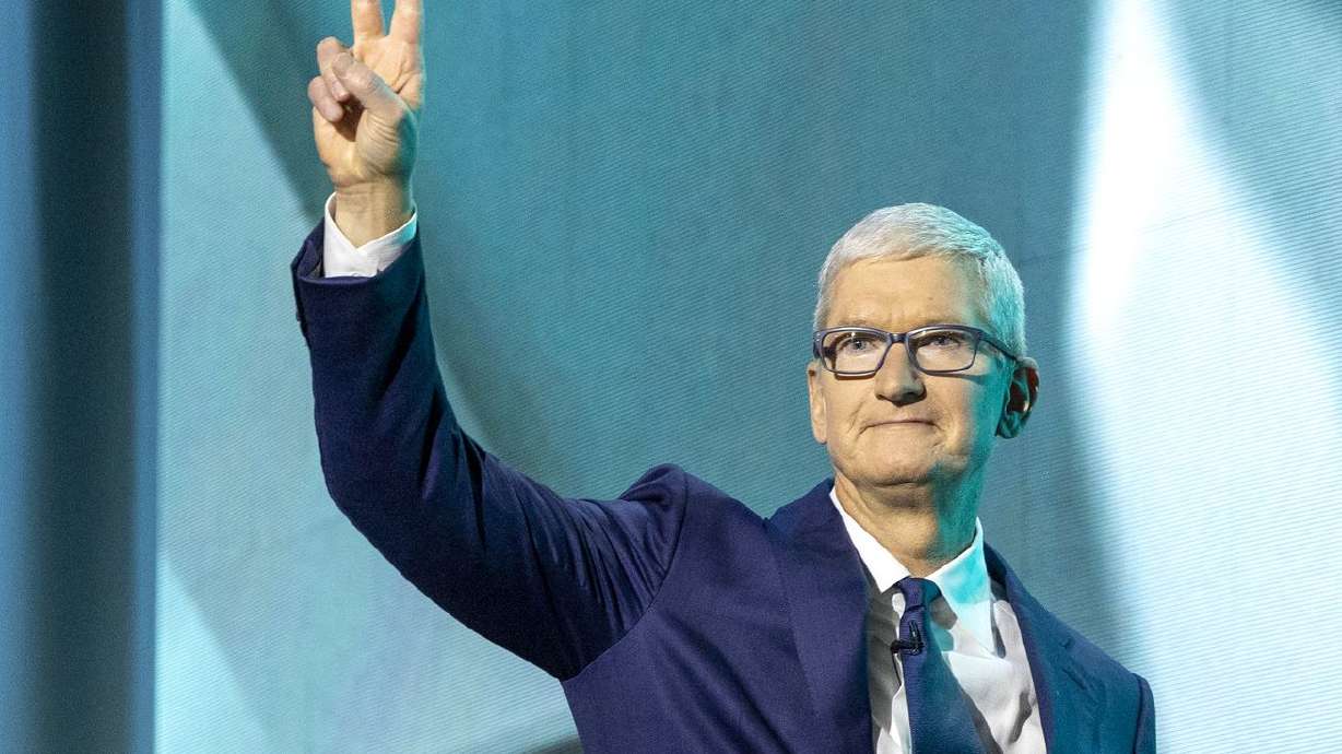 Apple CEO Tim Cook acknowledges the crowd as he walks onto the stage during the Silicon Slopes Summit in Salt Lake City, Oct. 13.