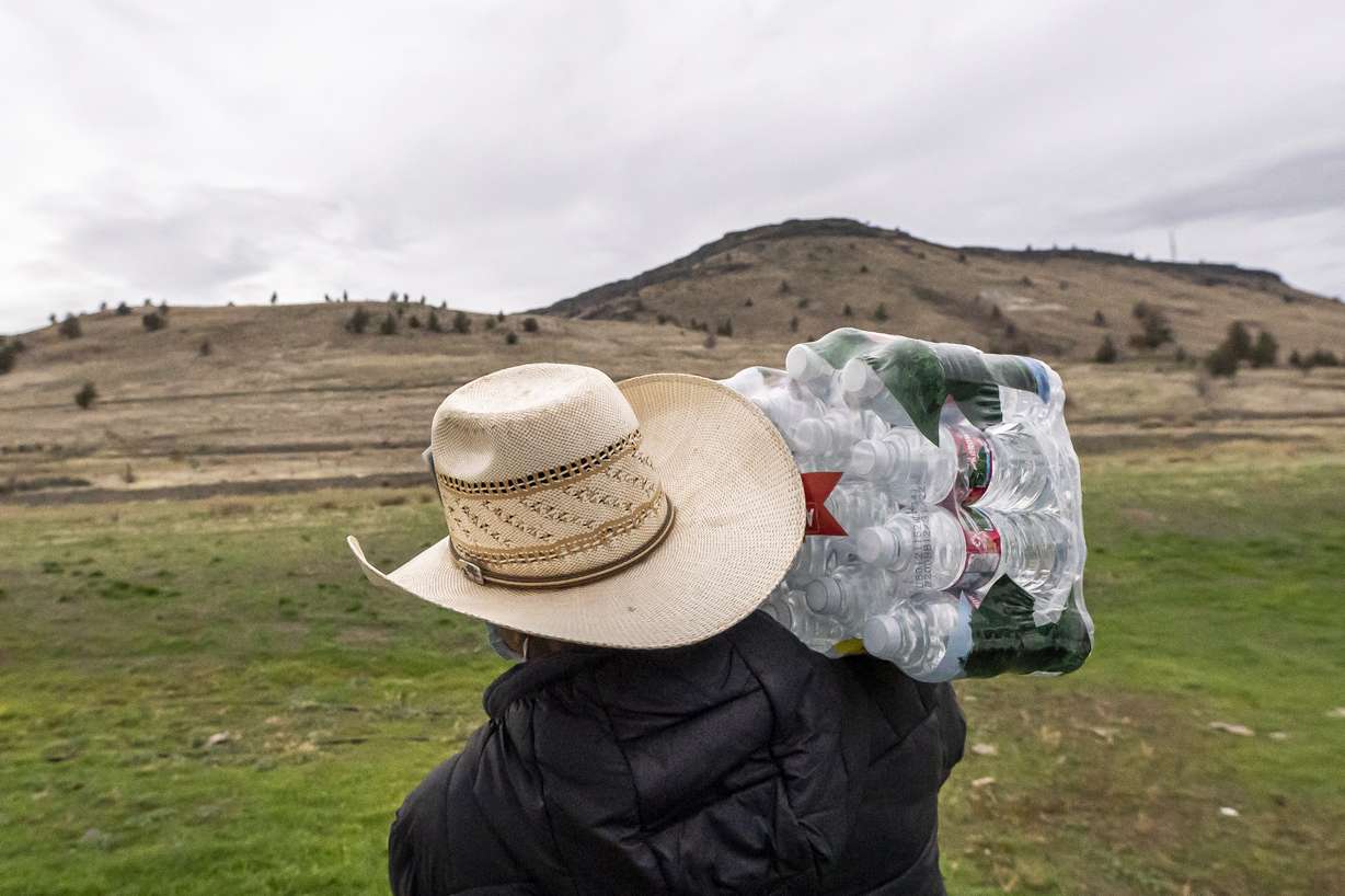 Hazen Bru delivers donated water to residents of the Confederated Tribes of Warm Springs on Monday, Dec. 6, 2021, in Warm Springs, Ore. The massive infrastructure bill signed earlier this year promises to bring change to many Native American tribes that lack clean water or indoor plumbing through the largest single infusion of money into Indian Country.