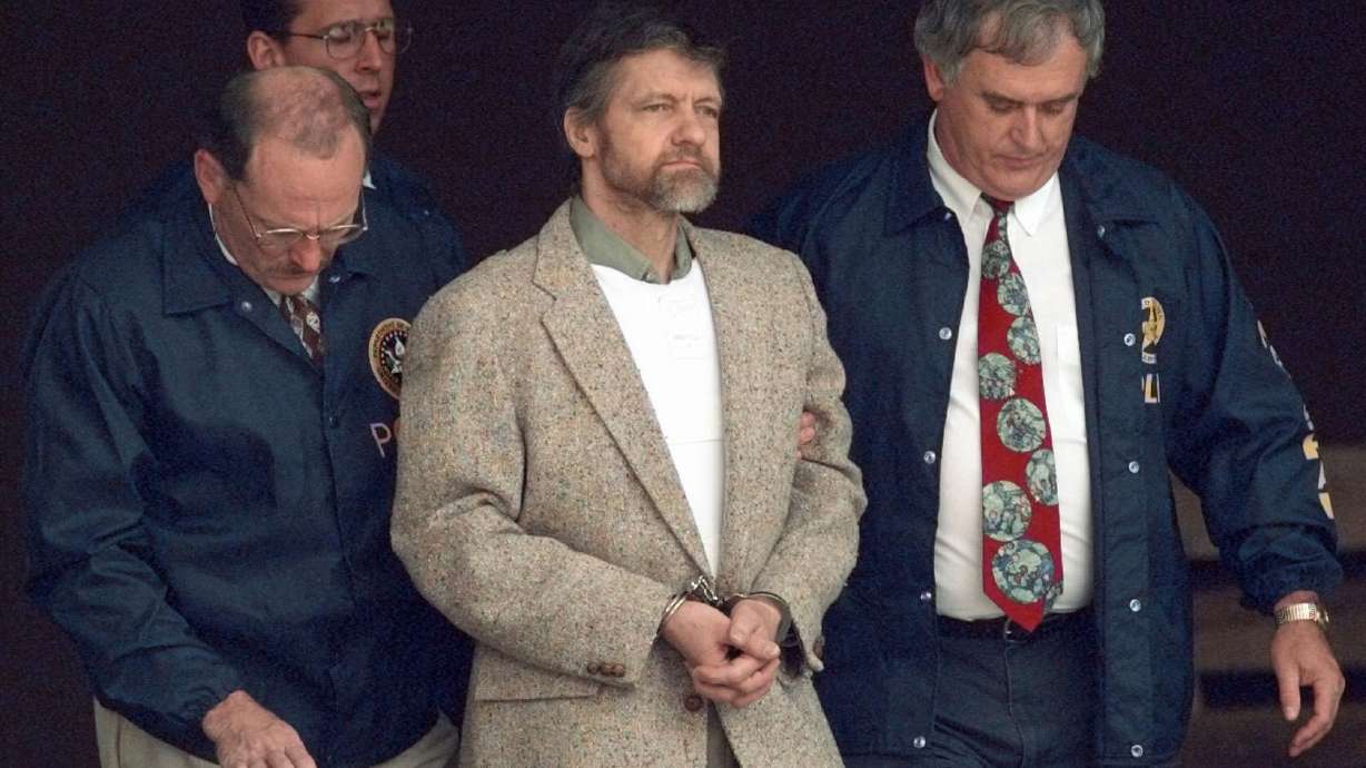 Theodore Kaczynski looks around as U.S. Marshals prepare to take him down the steps at the federal courthouse to a waiting vehicle on June 21, 1996, in Helena, Mont. Earlier this month, he was moved from a Supermax prison to a medical facility.