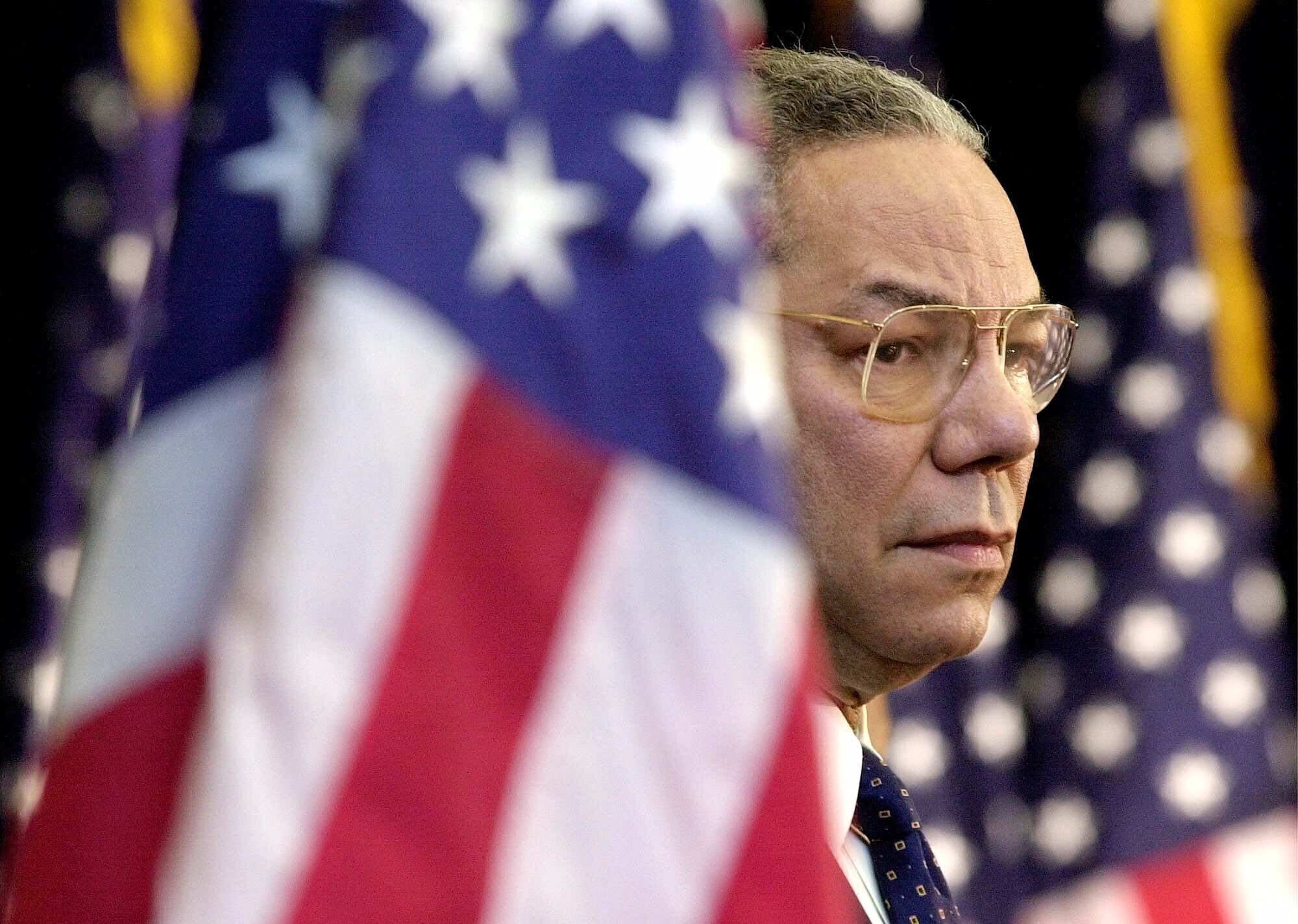 Secretary of State Colin Powell looks on as President Bush addresses State Department employees at the State Department in Washington, on Feb. 15, 2001. Powell, who died Oct. 18, 2021, was a trailblazing soldier and diplomat.