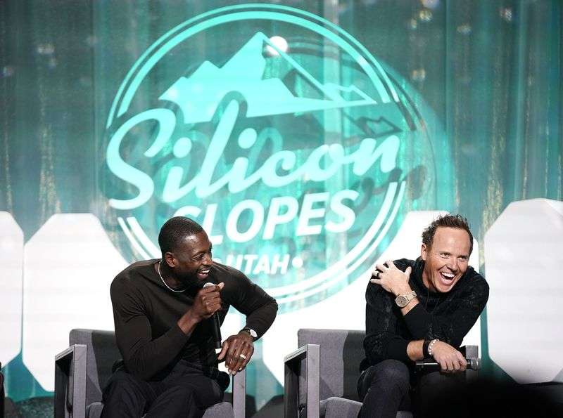 Dwyane Wade, part owner of the Utah Jazz, left, and
Jazz owner Ryan Smith laugh as they talk about rebranding effort
for the team at the Silicon Slopes Summit at the Salt Palace in
Salt Lake City on Oct. 13, 2021.