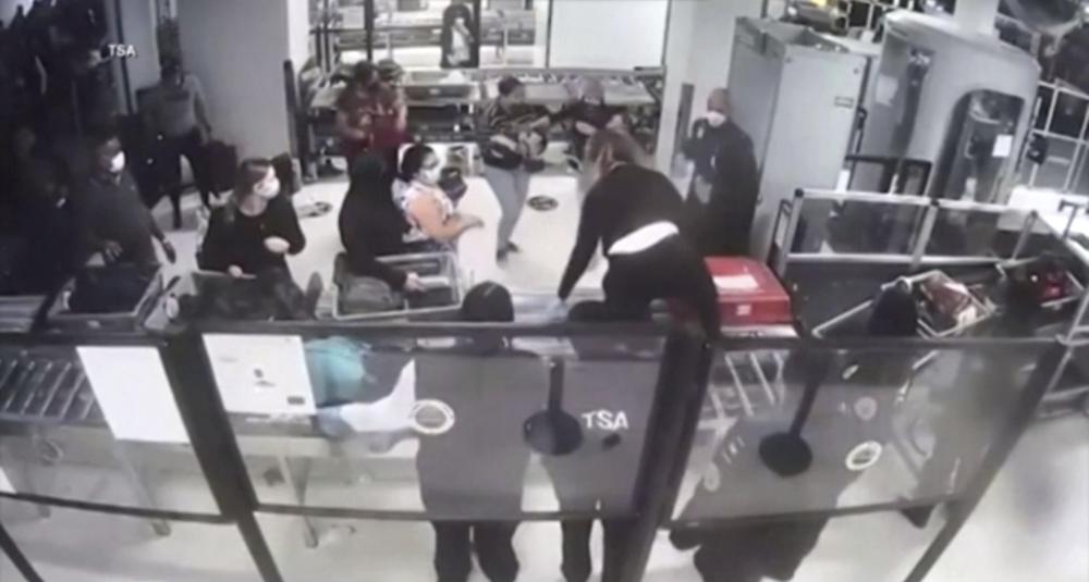Transportation Security Administration officer Cecilia Morales jumps over a conveyor belt at a security checkpoint to assist a mother with an unresponsive baby, performing a life-saving maneuver on Dec. 9 at Newark Liberty International Airport in Newark,