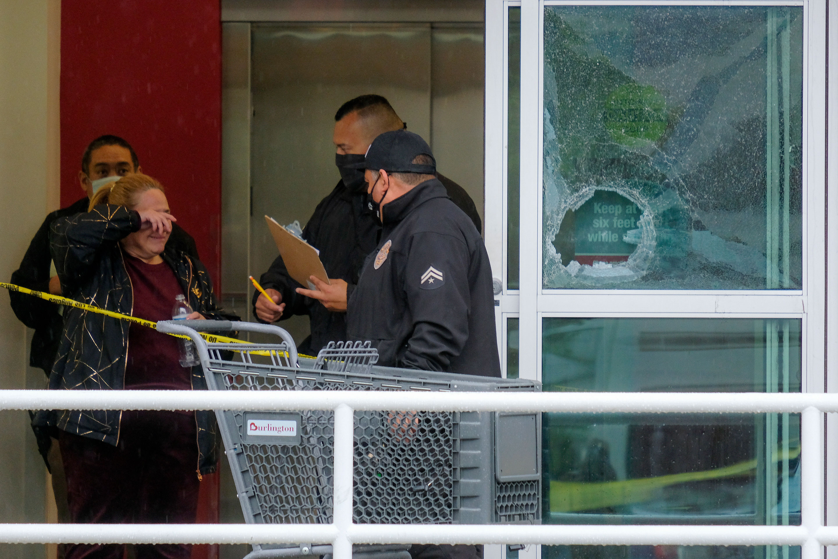 Police officers investigate the scene where two people were struck by gunfire in a shooting at a Burlington store as part of a chain formerly known as Burlington Coat Factory in North Hollywood, Calif., Thursday.