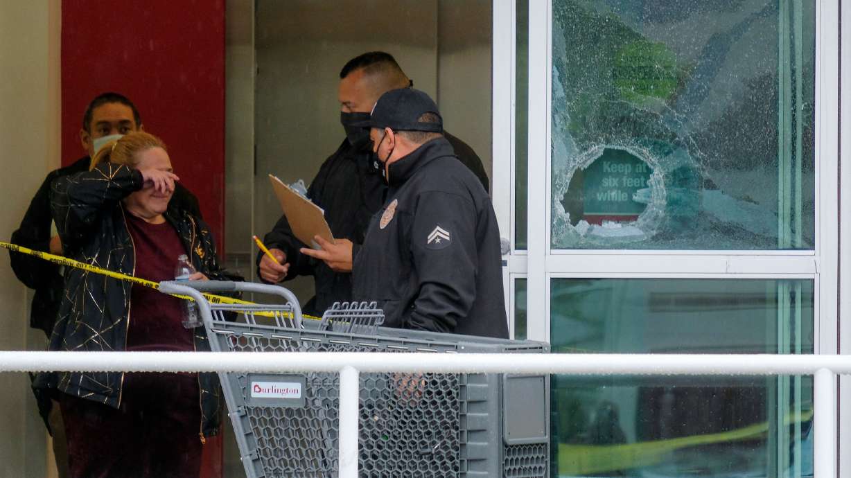 Police officers investigate the scene where two people were struck by gunfire in a shooting at a Burlington store as part of a chain formerly known as Burlington Coat Factory in North Hollywood, Calif., Thursday.