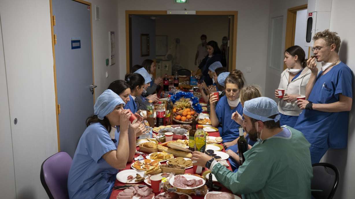 Doctors and nurses share a Christmas Eve meal together in the COVID-19 intensive care unit at la Timone hospital in Marseille, southern France, Friday.
