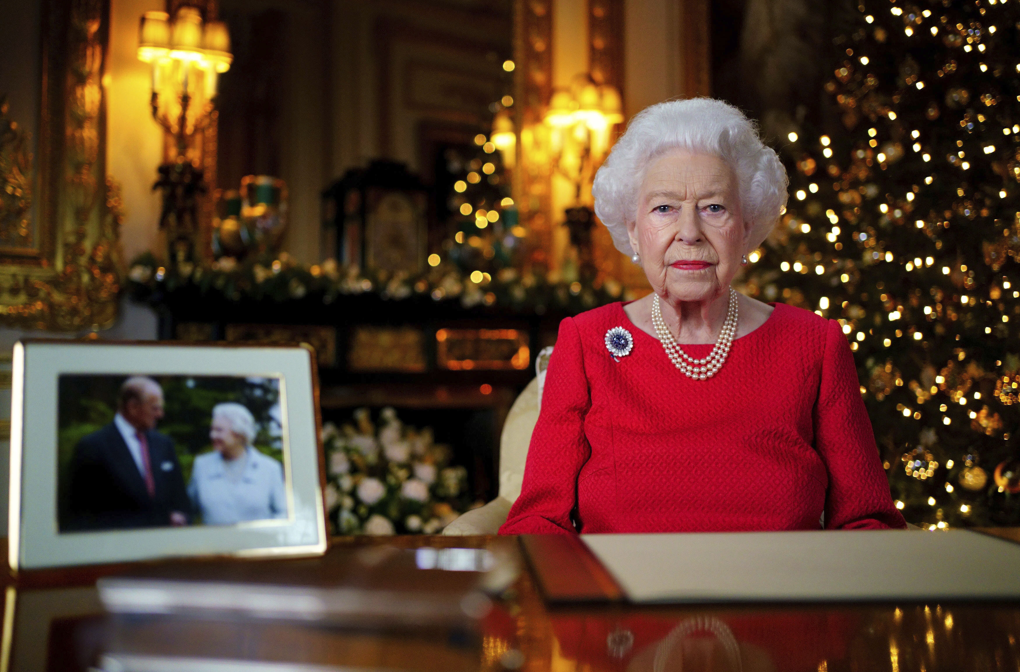 In this undated photo issued on Thursday, Britain's Queen Elizabeth II records her annual Christmas broadcast in Windsor Castle, Windsor, England. The photograph at left shows The Queen and Prince Philip taken in 2007 at Broadlands to mark their Diamond wedding anniversary. 