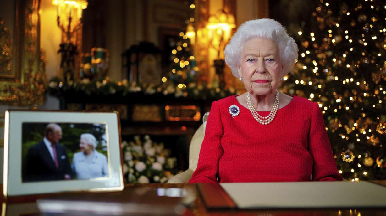 In this undated photo issued on Thursday, Britain's Queen Elizabeth II records her annual Christmas broadcast in Windsor Castle, Windsor, England. The photograph at left shows The Queen and Prince Philip taken in 2007 at Broadlands to mark their Diamond wedding anniversary.