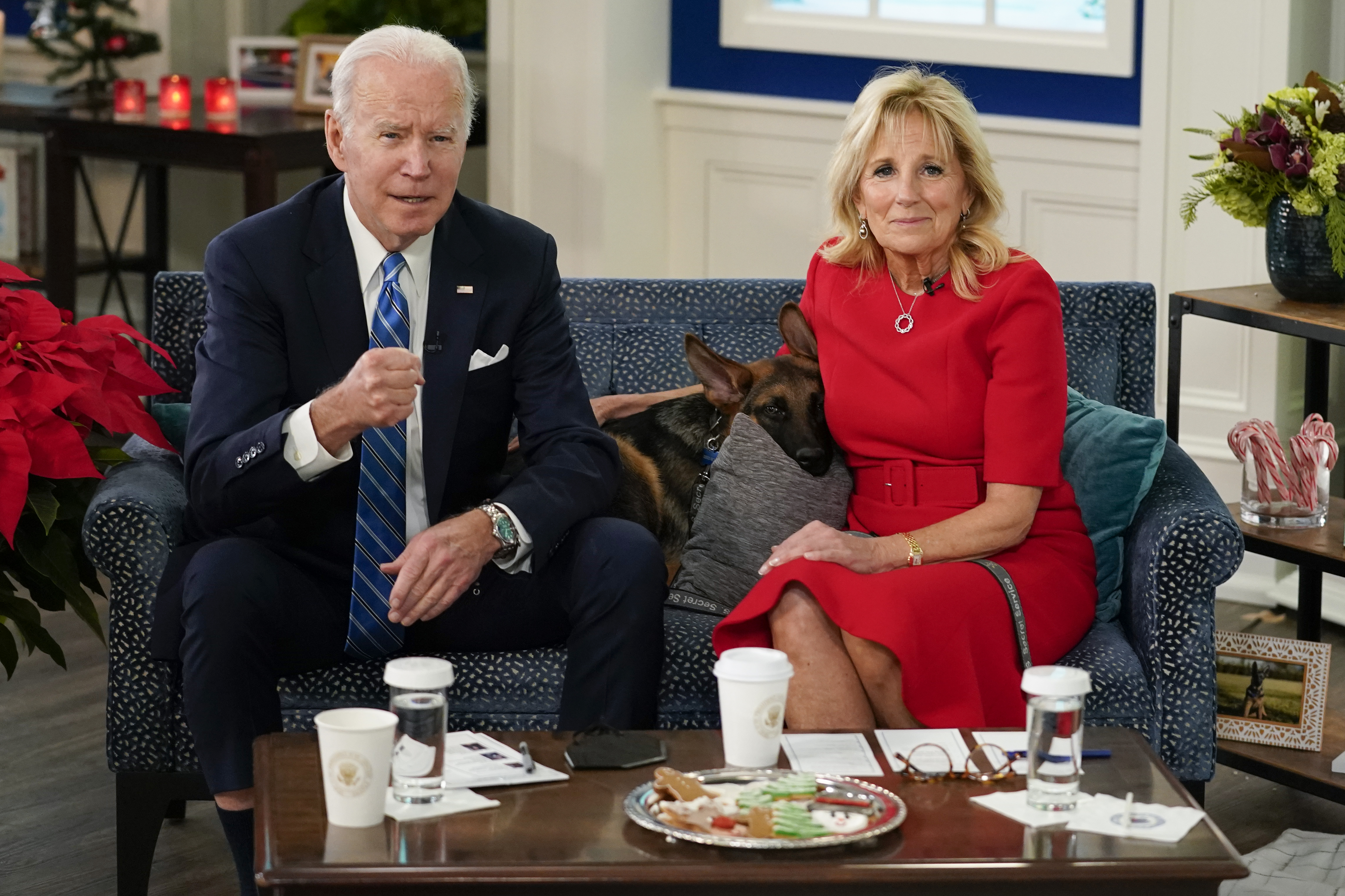 President Joe Biden, first lady Jill Biden and their new dog Commander, a purebred German shepherd puppy, meet virtually with service members around the world, Saturday, in the South Court Auditorium on the White House campus in Washington, to thank them for their service and wish them a Merry Christmas. 