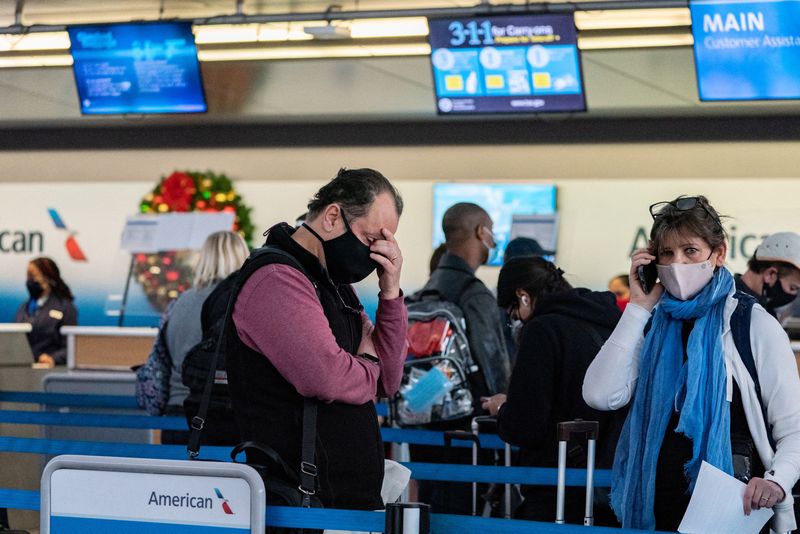 Passengers line up at John F. Kennedy International Airport in Queens, New York City, Sunday.