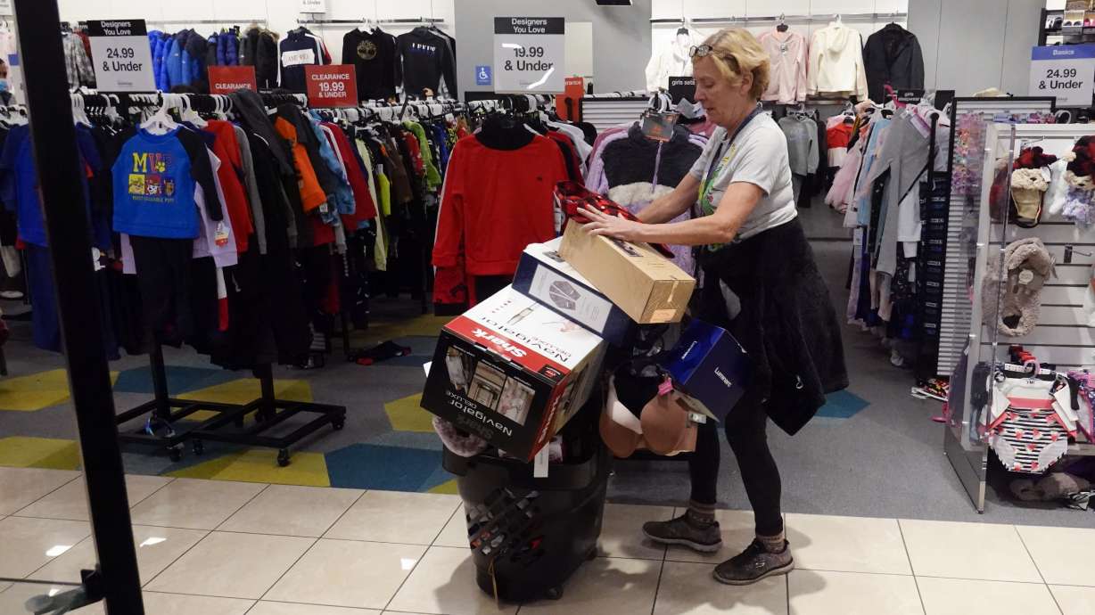 A shopper pushes her cart during a Black Friday sale Nov. 26, in Indianapolis. Holiday sales rose at the fastest pace in 17 years, according to one spending measure.